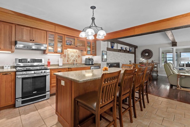 N3510 Lotus Dr, Montello, WI 53949 - kitchen with gas stove, under cabinet range hood, brown cabinets, beamed ceiling, and a chandelier