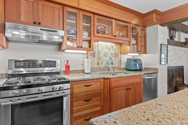 N3510 Lotus Dr, Montello, WI 53949 - kitchen featuring stainless steel appliances, under cabinet range hood, brown cabinetry, and light stone countertops