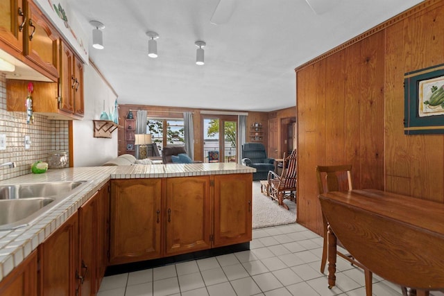 N3510 Lotus Dr, Montello, WI 53949 - kitchen with a peninsula, brown cabinets, tile countertops, decorative backsplash, and open floor plan