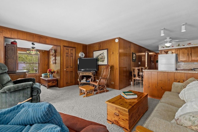 N3510 Lotus Dr, Montello, WI 53949 - living area with light carpet, wood walls, and ceiling fan