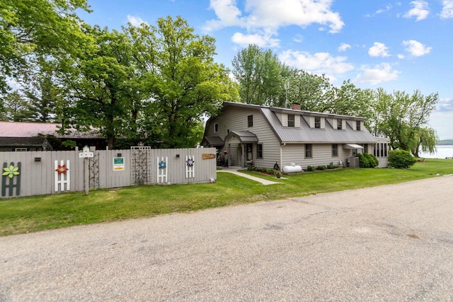 N3510 Lotus Dr, Montello, WI 53949 - view of home's exterior with a gambrel roof, metal roof, a chimney, and a gate