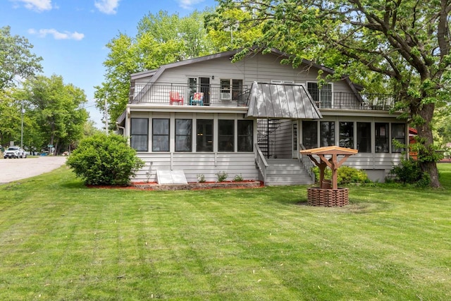 N3510 Lotus Dr, Montello, WI 53949 - rear view of house with a balcony, stairs, and a lawn