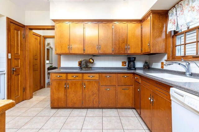 326 W Parkway Blvd, Appleton, WI 54911 - kitchen featuring white dishwasher, a sink, brown cabinets, and backsplash