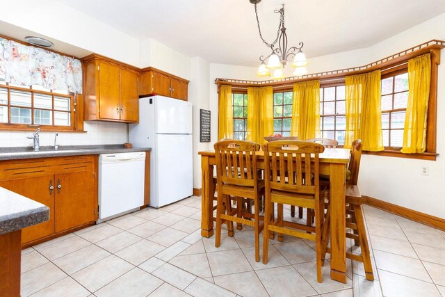 326 W Parkway Blvd, Appleton, WI 54911 - kitchen with white appliances, a chandelier, healthy amount of natural light, and backsplash