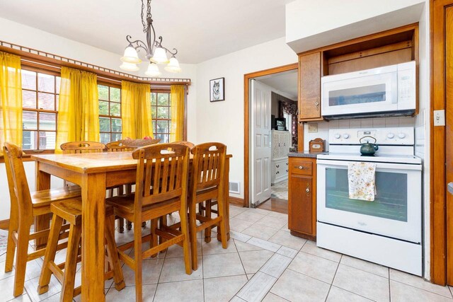326 W Parkway Blvd, Appleton, WI 54911 - dining area with a chandelier and light tile patterned floors