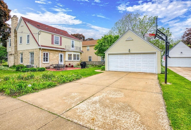 326 W Parkway Blvd, Appleton, WI 54911 - view of front of property with an outdoor structure, stone siding, a detached garage, and a chimney