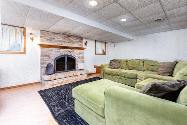 326 W Parkway Blvd, Appleton, WI 54911 - living room featuring wood finished floors, a fireplace, a paneled ceiling, and baseboards