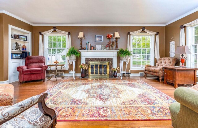 326 W Parkway Blvd, Appleton, WI 54911 - living area featuring plenty of natural light, wood finished floors, ornamental molding, and a premium fireplace