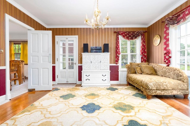 326 W Parkway Blvd, Appleton, WI 54911 - living area featuring wallpapered walls, a chandelier, healthy amount of natural light, crown molding, and wood finished floors