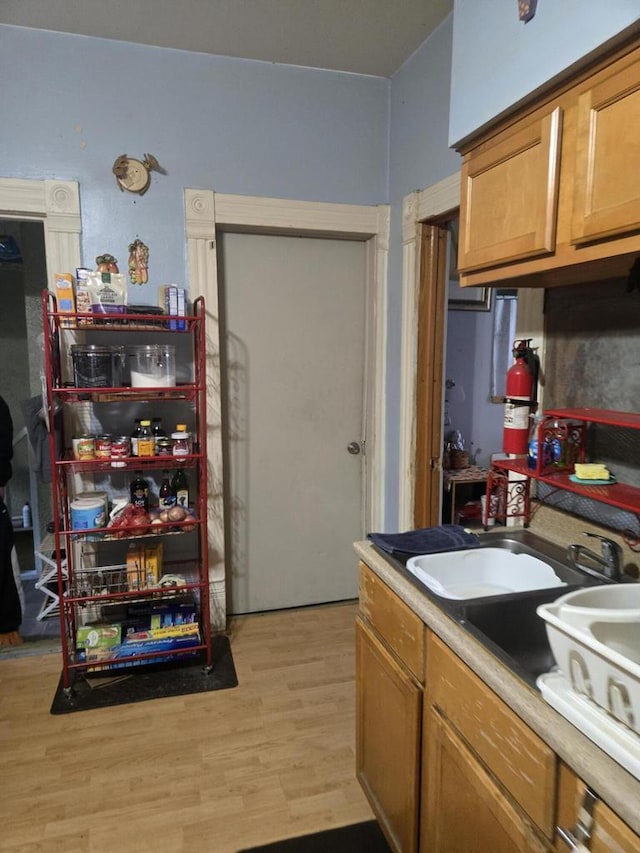 443 Dunbar Ave, Waukesha, WI 53186 - kitchen with light wood finished floors and brown cabinetry
