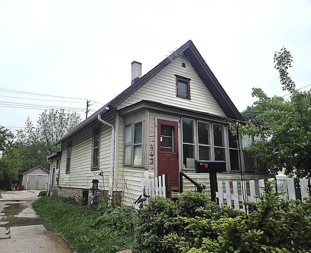 443 Dunbar Ave, Waukesha, WI 53186 - view of front facade featuring a chimney and a detached garage