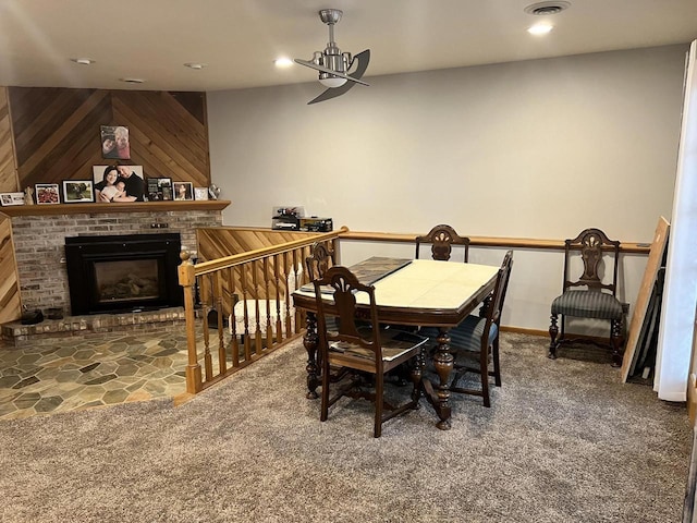 1159 Elmhurst Ln, Oshkosh, WI 54904 - dining room featuring carpet, wooden walls, a brick fireplace, and recessed lighting