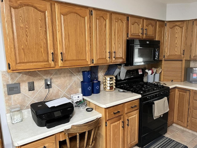 1159 Elmhurst Ln, Oshkosh, WI 54904 - kitchen with black appliances, light countertops, and brown cabinets