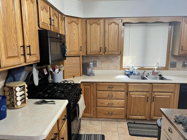 1159 Elmhurst Ln, Oshkosh, WI 54904 - kitchen featuring black appliances, a sink, backsplash, light tile patterned floors, and brown cabinetry