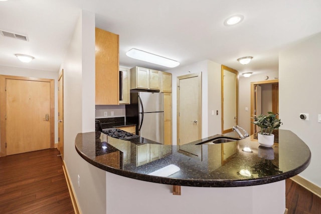 333 W Mifflin St Unit 8100, Madison, WI 53703 - kitchen with freestanding refrigerator, a peninsula, a sink, baseboards, and dark stone countertops