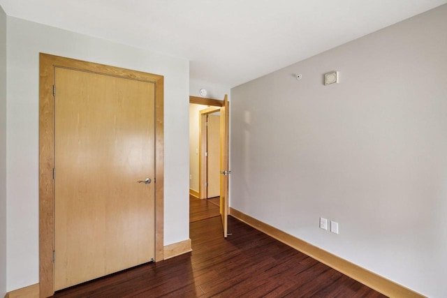 333 W Mifflin St Unit 8100, Madison, WI 53703 - unfurnished bedroom featuring dark wood-style floors and baseboards