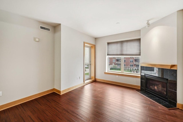 333 W Mifflin St Unit 8100, Madison, WI 53703 - unfurnished living room featuring baseboards, a fireplace, and wood finished floors
