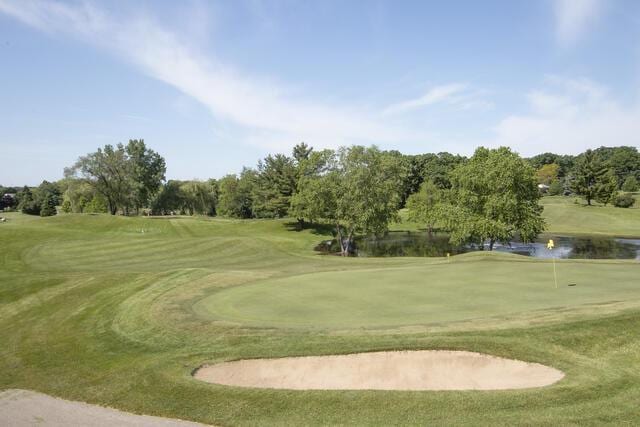 390 County Road B, Fontana, WI 53125 - view of community featuring golf course view, a putting green, a water view, and view of wooded area