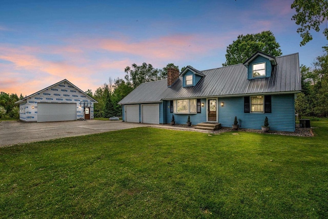 W4593 Old 352 Rd, Stephenson, MI 49887 - view of front of house featuring metal roof, a front yard, a detached garage, and a chimney