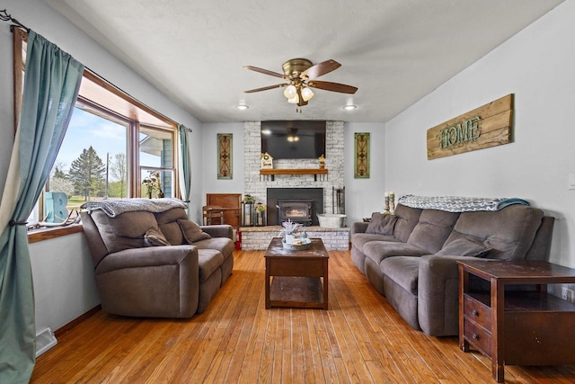 W4593 Old 352 Rd, Stephenson, MI 49887 - living room with ceiling fan, light wood-type flooring, a fireplace, and baseboards