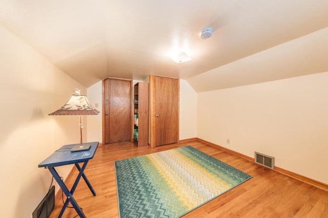 2114 S 81st St, West Allis, WI 53219 - additional living space with lofted ceiling, wood finished floors, and baseboards