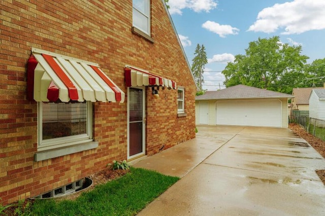 2114 S 81st St, West Allis, WI 53219 - view of property exterior featuring a garage, an outdoor structure, and brick siding