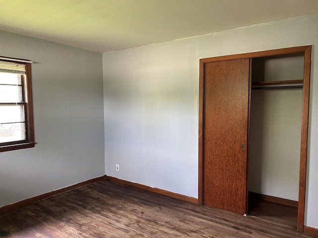 965 Appleton Rd, Menasha, WI 54952 - unfurnished bedroom with dark wood-style flooring, a closet, and baseboards