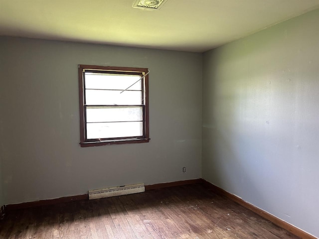 965 Appleton Rd, Menasha, WI 54952 - empty room with a baseboard heating unit, dark wood-type flooring, and baseboards