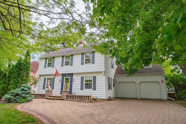 963 W Highland St, Whitewater, WI 53190 - colonial home featuring decorative driveway, an attached garage, and a chimney