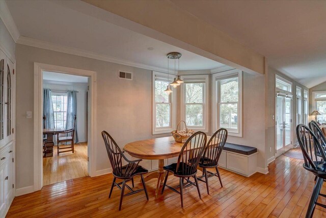 963 W Highland St, Whitewater, WI 53190 - dining area with light wood-type flooring, healthy amount of natural light, ornamental molding, and baseboards