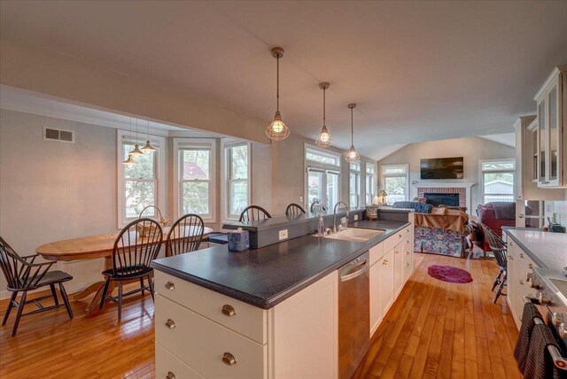 963 W Highland St, Whitewater, WI 53190 - kitchen with stainless steel appliances, a sink, light wood-type flooring, open floor plan, and dark countertops