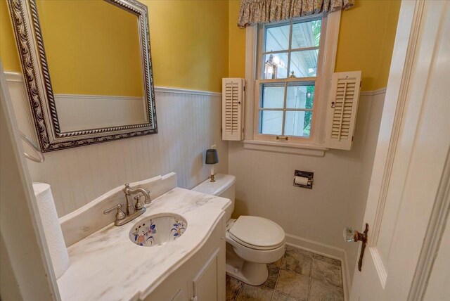 963 W Highland St, Whitewater, WI 53190 - half bath with toilet, a wainscoted wall, and vanity