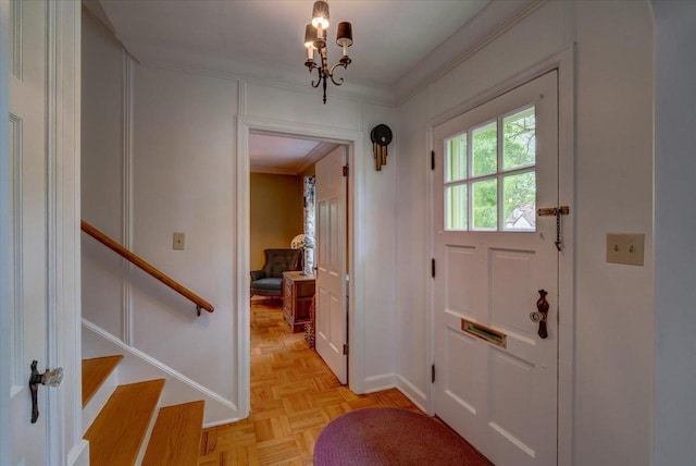 963 W Highland St, Whitewater, WI 53190 - foyer with ornamental molding, stairs, and a chandelier