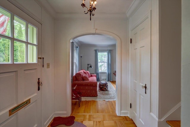 963 W Highland St, Whitewater, WI 53190 - entryway featuring arched walkways, crown molding, light wood-style floors, and baseboards