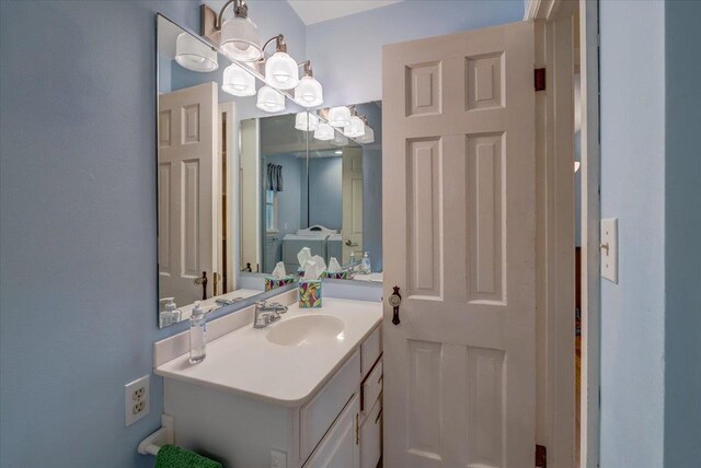 963 W Highland St, Whitewater, WI 53190 - bathroom featuring vanity and a chandelier