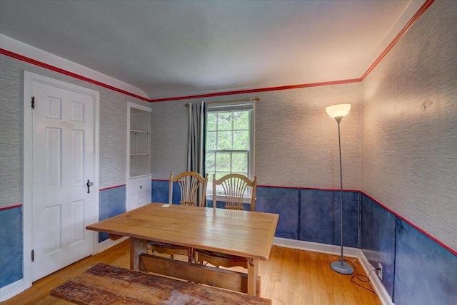 963 W Highland St, Whitewater, WI 53190 - dining area with wood finished floors, a wainscoted wall, crown molding, and wallpapered walls
