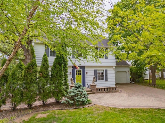 963 W Highland St, Whitewater, WI 53190 - view of front of house featuring an attached garage and decorative driveway