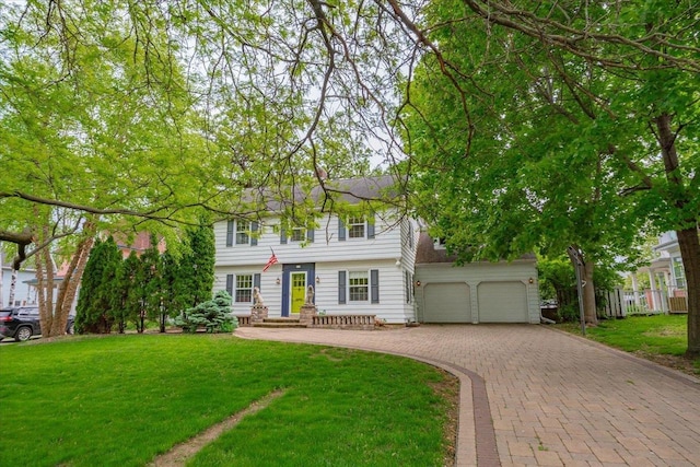 963 W Highland St, Whitewater, WI 53190 - colonial-style house featuring decorative driveway and an attached garage