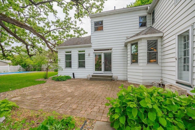 963 W Highland St, Whitewater, WI 53190 - back of property with a patio area, entry steps, and roof with shingles