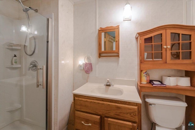9298 E Park Ave, Solon Springs, WI 54873 - bathroom with a shower stall, vanity, tile walls, and toilet
