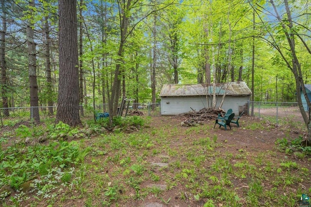 9298 E Park Ave, Solon Springs, WI 54873 - fenced backyard with a forest view and an outbuilding