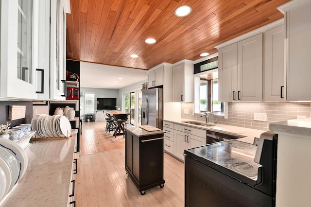N60W39640 Mary Ln, Oconomowoc, WI 53066 - kitchen with stainless steel fridge, a sink, wood ceiling, recessed lighting, and black range with electric cooktop