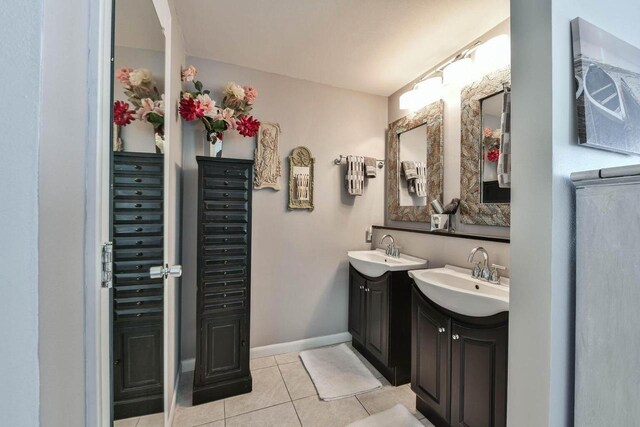 N60W39640 Mary Ln, Oconomowoc, WI 53066 - full bathroom featuring two vanities, tile patterned floors, and baseboards