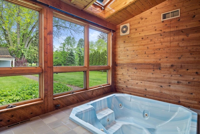 N60W39640 Mary Ln, Oconomowoc, WI 53066 - full bathroom featuring vaulted ceiling, a skylight, wood walls, a jetted tub, and tile patterned flooring