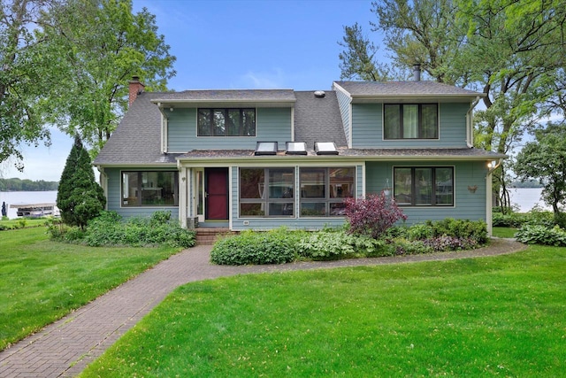 N60W39640 Mary Ln, Oconomowoc, WI 53066 - view of front of home with a chimney, a front yard, and roof with shingles
