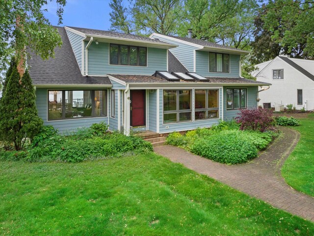 N60W39640 Mary Ln, Oconomowoc, WI 53066 - view of front of home with a front lawn and roof with shingles
