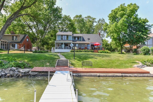 N60W39640 Mary Ln, Oconomowoc, WI 53066 - dock with a lawn and a deck with water view