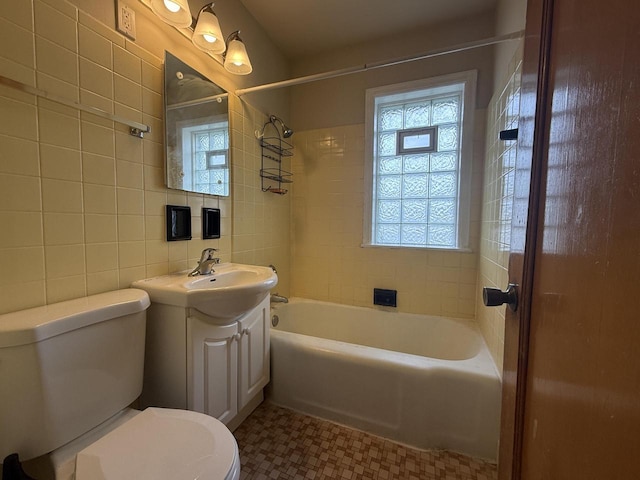 2740 N 61st St, Milwaukee, WI 53210 - bathroom featuring toilet, vanity, tile walls, and shower / tub combination