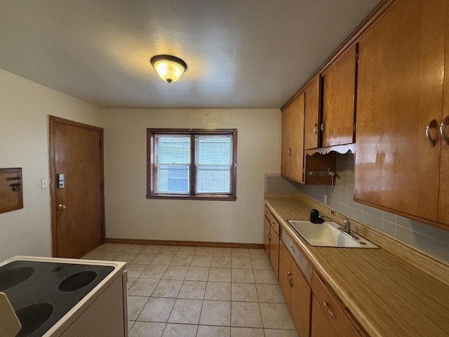2740 N 61st St, Milwaukee, WI 53210 - kitchen featuring brown cabinets, a sink, range with electric cooktop, tasteful backsplash, and light tile patterned floors