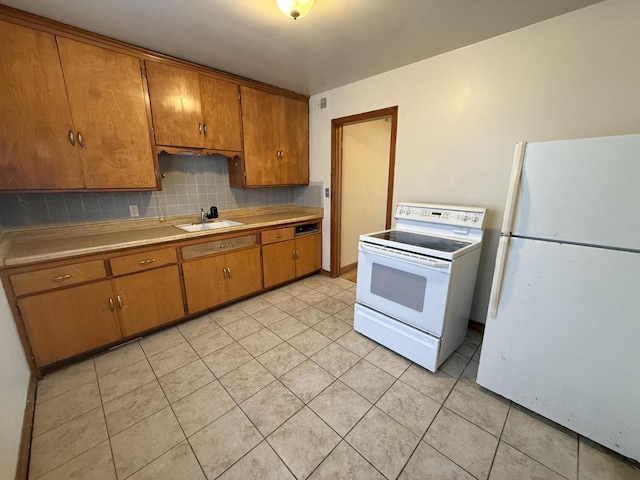 2740 N 61st St, Milwaukee, WI 53210 - kitchen with white appliances, a sink, brown cabinets, and light tile patterned floors